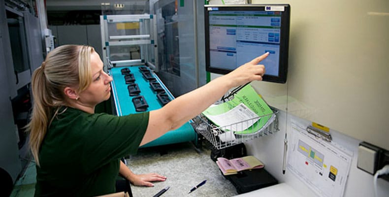 Factory worker using digital tablet at drinks production factory