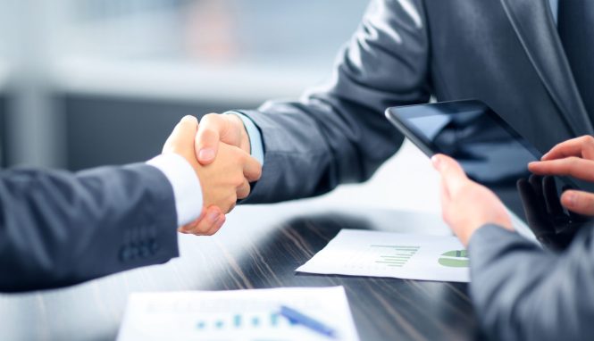 Business people shaking hands in office